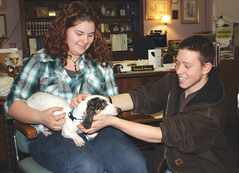 Mandi Steele/FULTON SUN photo: Missouri School for the Deaf students Catherine Slinkard and Michael Miller help take care of Sparky, a deaf dachshund the school recently adopted.