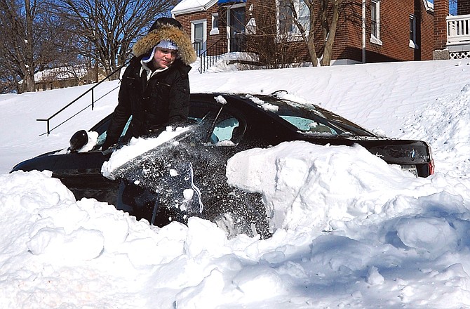 Katie Matheis shovels the snow away from her car Wednesday on West High Street. She was just one of many Jefferson City and area residents out in the bitter cold trying to dig their way out of the worst storm in years.
