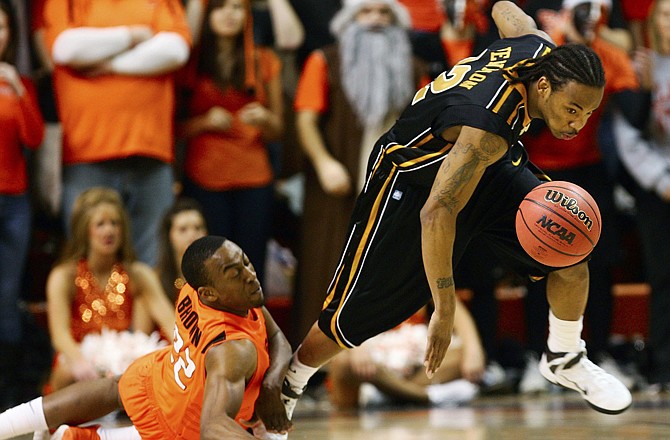 Missouri's Marcus Dixon Jr., right, steals the ball from Oklahoma State's Markel Brown during the first half of an NCAA college basketball game Wednesday, Feb. 2, 2011, in Stillwater, Okla.
