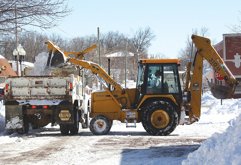 Mandi Steele/FULTON SUN photo: Fulton Street Department vehicles load snow to be carted off to Morningside, the city storage lot, Thursday morning. The department has been working around the clock trying to clear streets and cart away piles of snow from Tuesday's blizzard.