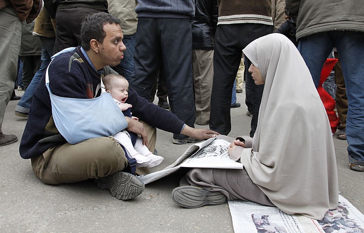 A family of anti-government protestors sits in Tahrir Square, Cairo, Egypt, Saturday, Feb. 5, 2011. Rallies in Cairo and behind-the-scenes diplomacy from the Obama administration is piling more pressure on Egyptian President Hosni Mubarak to make a swift exit and allow a temporary government to embark on an immediate path toward democracy. (AP Photo/Manoocher Deghati)