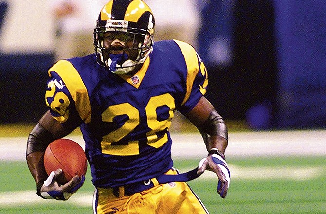 In this Jan. 16, 2000 file photo, St. Louis Rams running back Marshall Faulk rushes in the first half of an NFC divisional playoff game against the Minnesota Vikings in St. Louis.