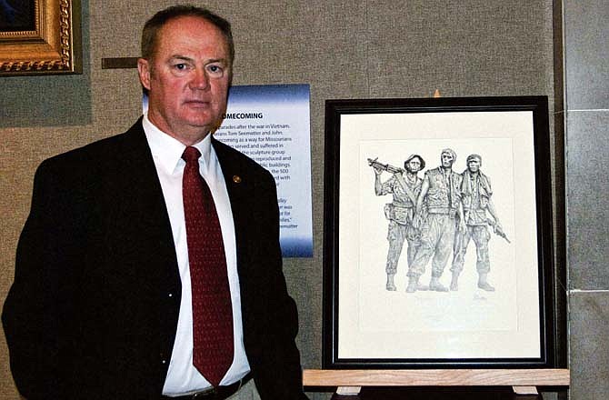 Rep. Paul Fitzwater, R-Potosi, stands next to the artwork of Tom Seematter, a Vietnam veteran who served as the inspiration behind proposed legislation to recognize Missouri's Vietnam veterans. 