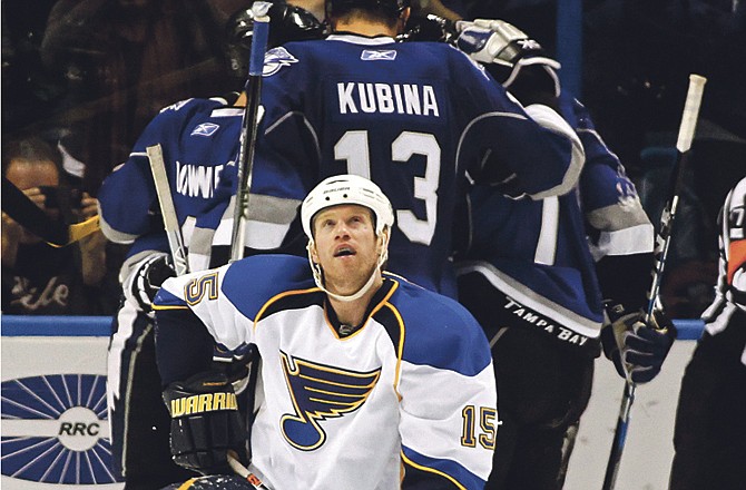 St. Louis Blues' Brad Winchester reacts as the Tampa Bay Lightning, including Pavel Kubina, or Czech Republic, celebrate a goal in the first period of an NHL hockey game Sunday, Feb. 6, 2011, in Tampa, Fla. The Lightning won 4-3.
