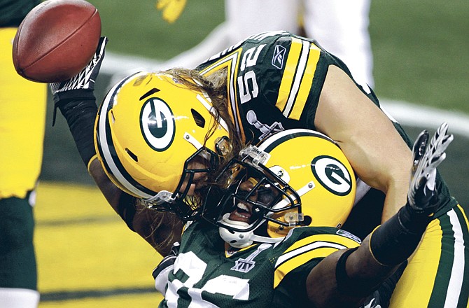 Green Bay Packers' Nick Collins (36) celebrates a touchdown with Clay Matthews (52) during the first half of NFL Super Bowl XLV football game against the Pittsburgh Steelers Sunday, Feb. 6, 2011, in Arlington, Texas. 