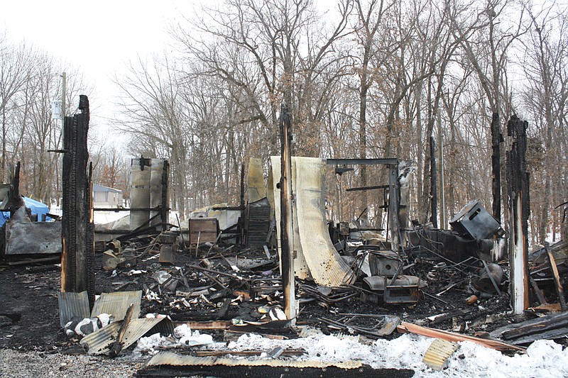 Mandi Steele/FULTON SUN photo: The charred remains of a storage shed are all that is left of the building after a fire demolished it Sunday. No injuries occurred, but everything inside the shed was lost.