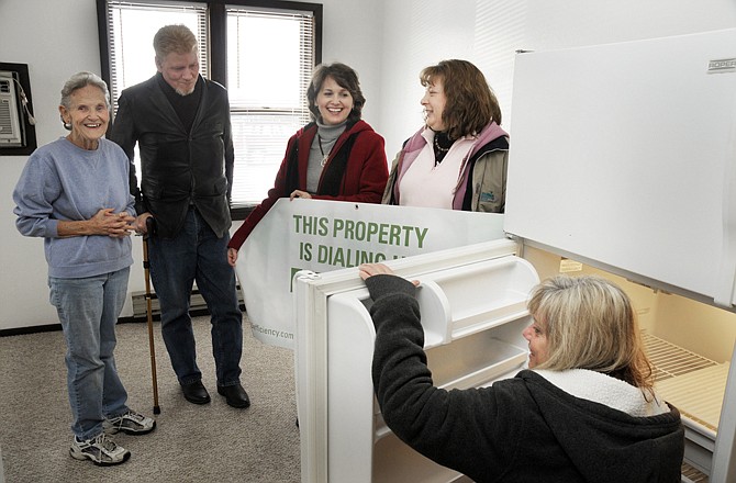 Sandy Schwaninger, right, checks the serial number on a refrigerator while local residents and board members Deva Steele, left, and Tye Hampton visit with Jaque Barker, second from right, and Nancy Long about appliance efficiency.