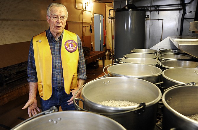 Longtime Lions' Club volunteer Harold Markway, Wardsville, explains the many steps involved in preparing beans for the annual Ham and Beans fundraiser Tuesday afternoon at the Selinger Center