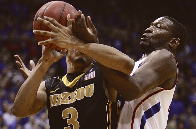 Kansas guard Mario Little, right, struggles for a rebound with Missouri guard Matt Pressey (3) during the first half of an NCAA college basketball game in Lawrence, Kan., Monday, Feb. 7, 2011.