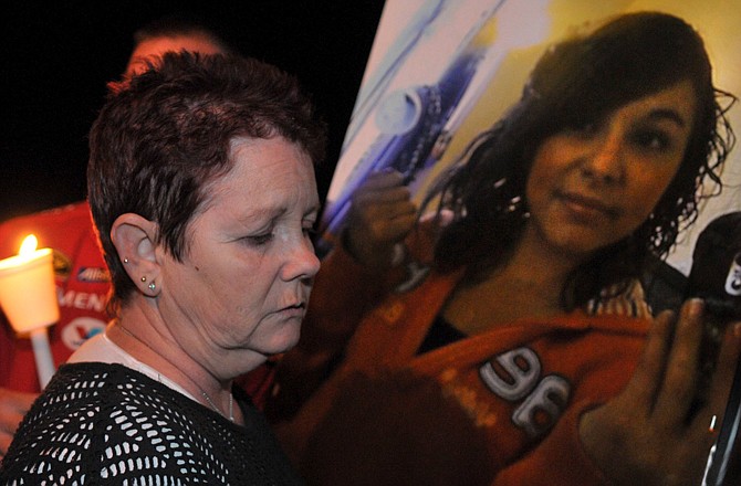 Trinidad Tarancon, grandmother of Danielle Taracon-Leon, holds a photo taken Tuesday of Danielle during a vigil for the seventh-grader, who was killed Wednesday when a pickup truck plowed into a group of students on the way to school.