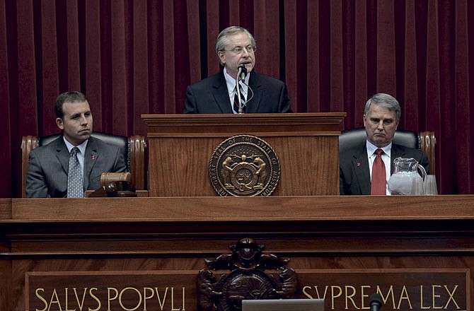 Judge Ray Price of the Missouri Supreme Court delivers the annual State of the Judiciary address in the Missouri House of Representative Chambers Wednesday morning. Seated at left is Speaker of the House, Rep. Steven Tilley and at right is President Pro Tem, Sen. Robert Mayer.