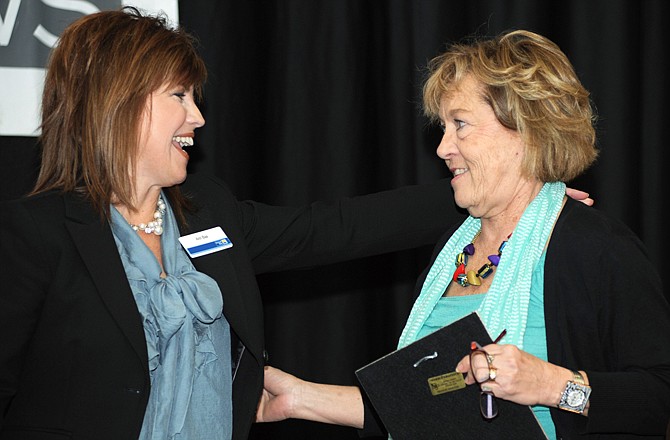 Debbie Hamler, right, thanks Ann Bax after receiving the Ruth C. Meloy Award during the United Way's annual meeting Friday at the Capitol Plaza Hotel. Bax is president of United Way of Central Missouri, and Hamler is executive director of The Special Learning Center.