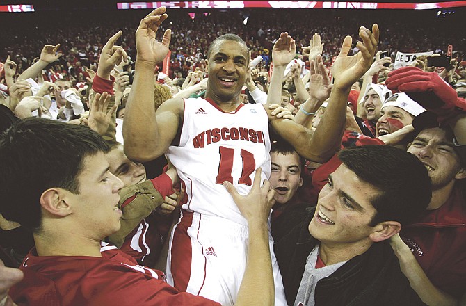 Wisconsin's Jordan Taylor celebrates with fans after beating undefeated No. 1 Ohio State 71-67 in an NCAA college basketball game against Ohio State Saturday, Feb. 12, 2011, in Madison, Wis.