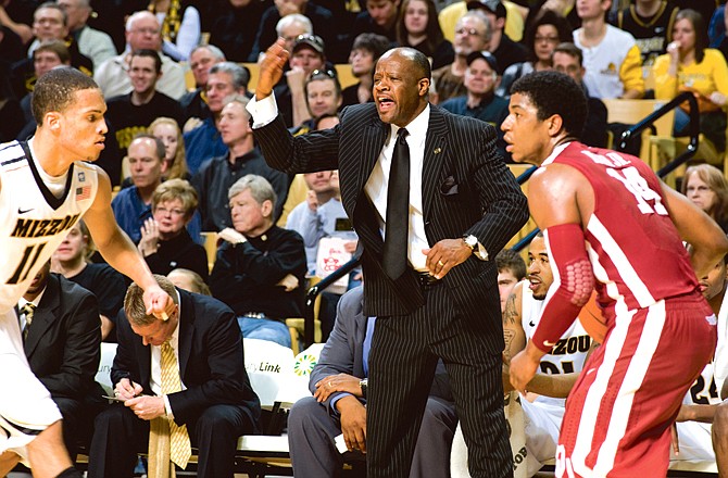 Missouri head coach Mike Anderson shouts instructions as Tiger guard Michael Dixon defends Oklahoma's Carl Blair during Saturday afternoon's game at Mizzou Arena. Dixon came off the bench to score a team-high 16 points in Missouri's 84-61 win.