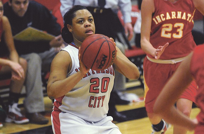 Jasmine Jimmerson gets ready to shoot a 3-pointer as Brittany Carter of Incarnate Word rushes to defend during Tuesday night's game at Fleming Fieldhouse. 