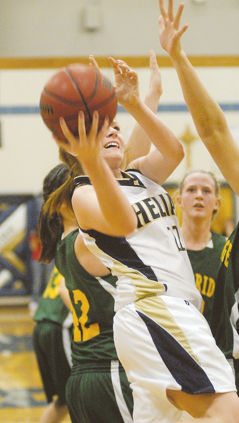 Helias' Arielle Chambers drives her way to two of her team-high 14 points during Thursday's game with Rock Bridge at Rackers Fieldhouse. To view this and other photographs, please visit www.newstribune.com/photos.