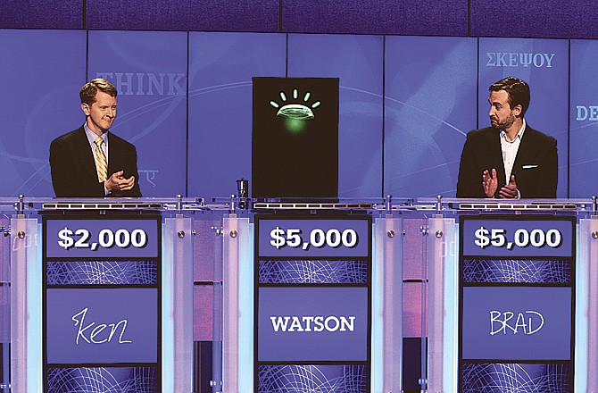 Contestants Ken Jennings, left, and Brad Rutter and a computer named Watson compete on the game show "Jeopardy!" in Yorktown Heights, N.Y.