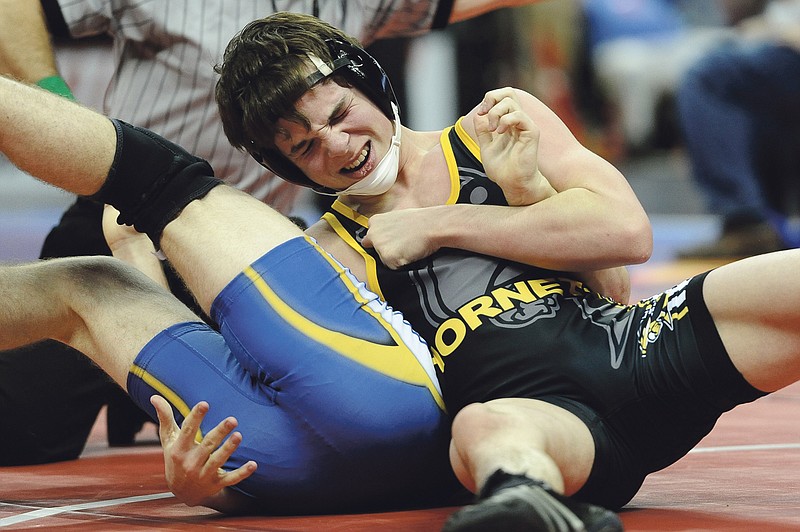 Dak Dillon/FULTON SUN photo: Fulton junior Zack McClure looks to finish off Bolivar junior Jesse Sherman with a pin in their first-round match at 130 pounds on Thursday. McClure eventually prevailed with a 12-3 major decision.