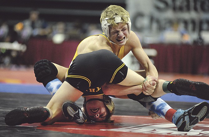 Fatima's Ryan Strope (top) tries to make a move on Lathrop's Tyler Mann during the Class 1 State Championships Saturday at Mizzou Arena. Mann notched a 7-2 win in the 112-pound championship match. 