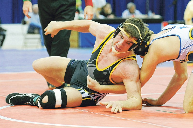 Dak Dillion/FULTON SUN: Fulton senior Ryan Fritz seeks an escape against Bolivar junior Aaron Allen in their third-place match at 171 pounds on Saturday in the Class 2 state championships at Mizzou Arena in Columbia. Fritz (34-2) capped off his high school career by pinning Allen in 1 minute, 52 seconds.