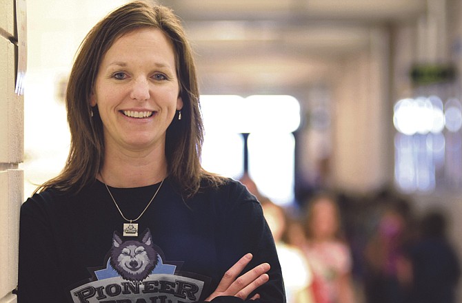 Students pass by school counselor Ruth Eichholz as they move between classrooms at Pioneer Trail Elementary School.