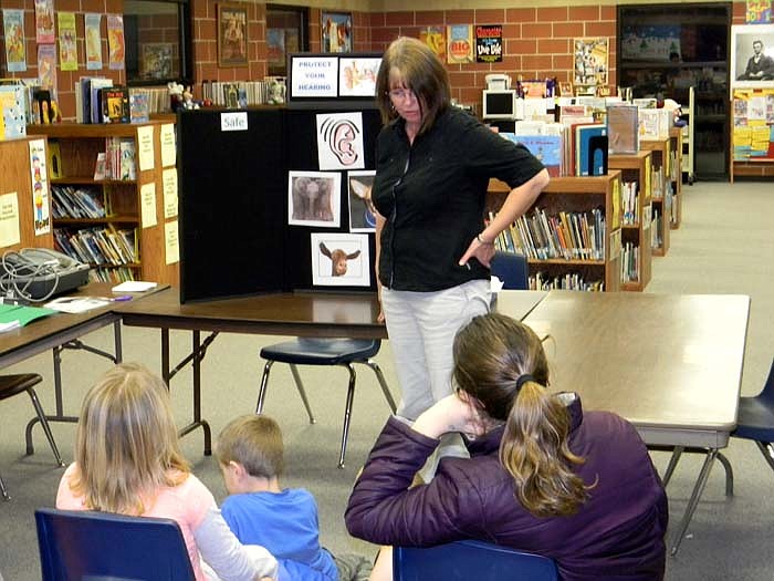 Avis Boie, RN, from the Moniteau County Health Center, talks about ear safety at the Family Fun Night.