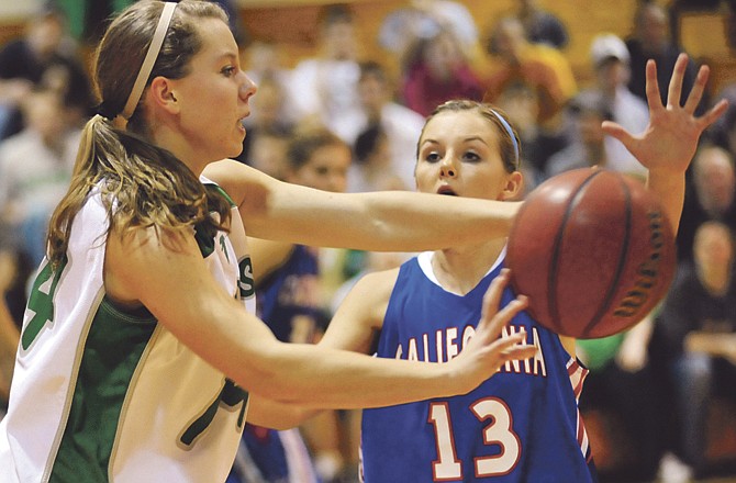 Jessica Fennewald of Blair Oaks and Kelci Dampf of California battle for control of the basketball during Monday night's game in Wardsville. 