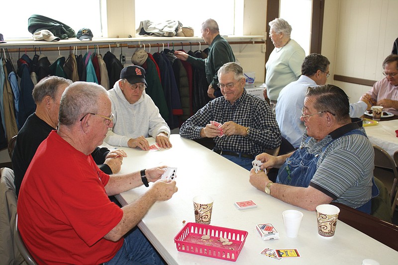 Mandi Steele/FULTON SUN photo: (From left) Walter Williams, Chuck Ball, Earl Ingrum, Robert Shuck and Donald Bryan play a game of five-point pitch Tuesday afternoon at Auxvasse Community Hall. The five men are all from Mexico and came to Auxvasse to participate in Loafer's Week. Card games and peanuts are two of the hallmarks of the community's longstanding winter tradition.