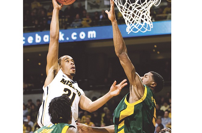 Missouri's Laurence Bowers, top left, shoots two of his game-high 20 points over Baylor's Perry Jones, right, as Anthony Jones, bottom left, and Ricardo Ratliffe, center, look on during the second half of an NCAA college basketball game, Wednesday, Feb. 23, 2011, in Columbia, Mo. No. 20 Missouri won the game 77-59. 
