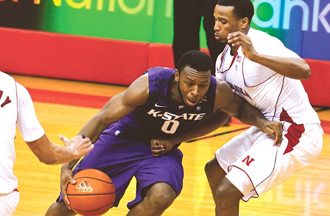 Jacob Pullen of Kansas State drives past Nebraska's Brandon Richardson during Wednesday night's game in Lincoln, Neb. Pullen had 27 points in Kansas State's 61-57 win.