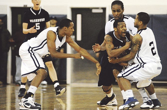 Blue Tiger guards Cedric Ridle, Jr., (12), left, Jimmy Payton, (23), center, and Pierre DeClue, (2), close in on Ichabod Jadarren Mumpfield, (4), during the game's final minute Saturday afternoon, Feb. 26, 2011, in Jason gym. Mumpfield called a time out, then Washburn defeated Lincoln University, 69-67.