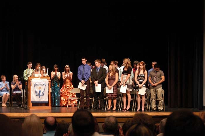 The new inductees and officers of the CHS Chapter of National Honor Societyand their officers are dismissed by incoming President Elle Miller. Outgoing President Donald Figgins is at the far left.