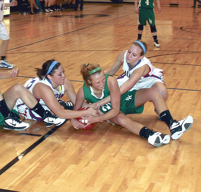 California's Kirstyn Roush, at left, and Lesa Langlotz, at right, scrap with a Lady Ranger for possession of the ball during the second quarter of the Lady Pintos' district game against Iberia.