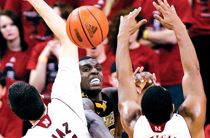 Missouri's Ricardo Ratliffe tries to pass the ball through the defense of Nebraska's Jorge Brian Diaz (21) and Lance Jeter (34) during the second half of Tuesday's game in Omaha, Neb.