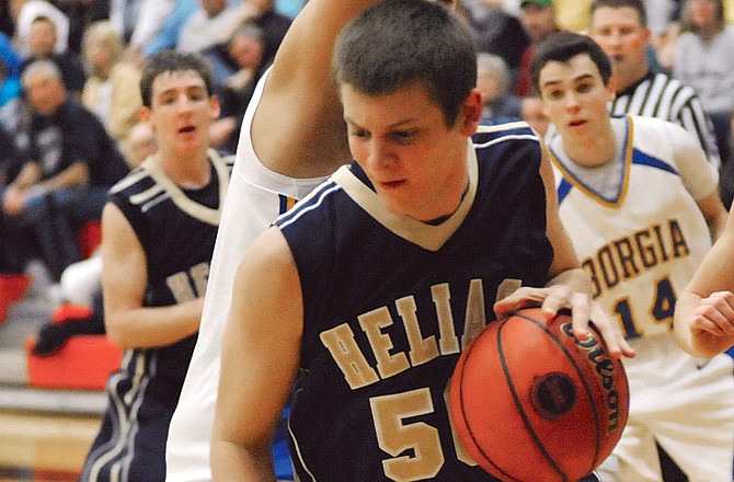Helias' Ryan Bax drives against St. Francis Borgia on Wednesday at Fleming Fieldhouse.