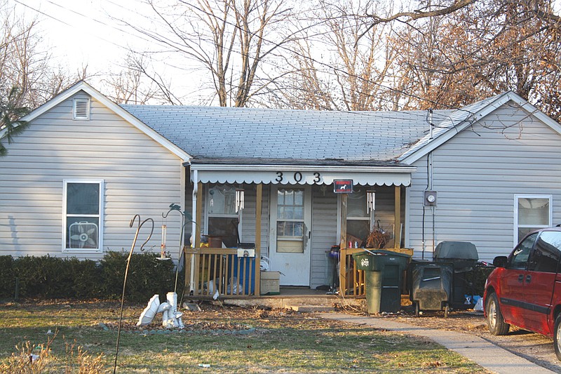 Mandi Steele/FULTON SUN photo: The residence at 303 W. 14th St. is where a Fulton postal worker was attacked by two pit bulls Tuesday afternoon. The black and red sign hanging from the eave of the house reads: "Warning: Security dog."