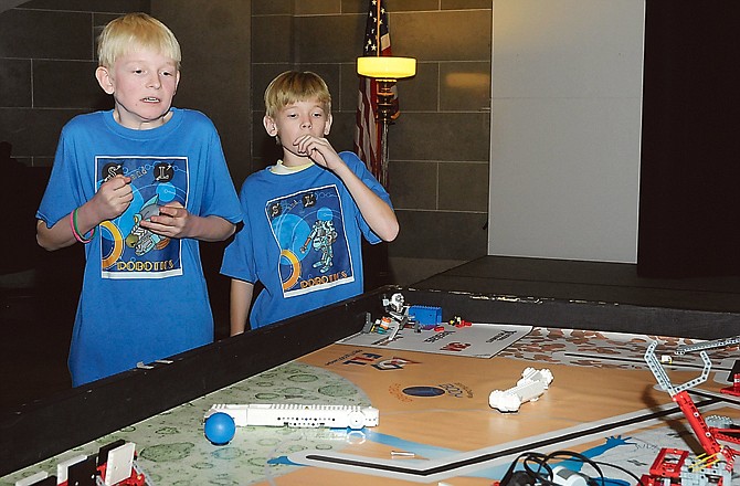 S&L Robitics members Lucas Winkelman, near, and Tanner Winkelman, react with concern as their robot makes its way to the next station during a robotics competition sponsored by the Missouri Chamber of Commerce and First LEGO League.