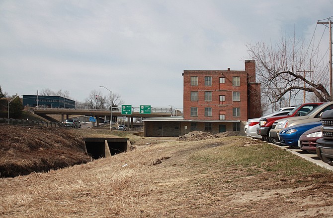 During meetings for "Greening America's Capitals," the groups discussed ideas such as creating a marketplace in a parking lot near an abandoned shoe factory near the interchange of U.S. 50/63 and U.S. 54. The factory could be converted into residential and business space, the groups suggested.