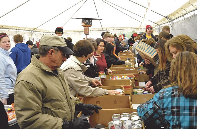 Volunteers help sort the food collected during the citywide Scouting for Food on Saturday at the Samaritan Center. 