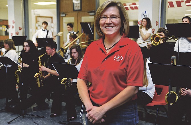 Jay Band booster Nancy Gibler stands in front of the Jazz Band during a short break in her duties at the annual spaghetti dinner on Thursday evening in the school's cafeteria. March is Music in Our Schools Month. 
