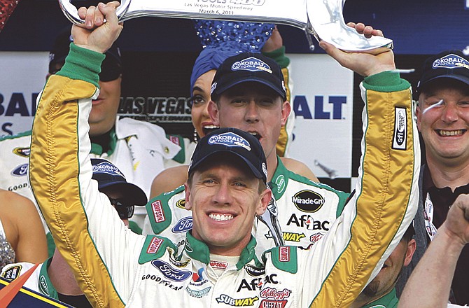 File photo: Columbia native Carl Edwards celebrates his victory Sunday in Las Vegas. 