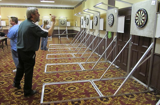 Steve Brown, the top-ranked dart player in the U.S. in 2009 and 2010, takes aim on Sunday during the 35th annual St. Patrick's Day Dart Tournament in Jefferson City. The three-day tournament at Truman Hotel drew competitors from more than a half-dozen other states.