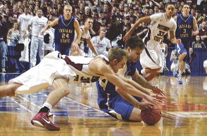 Aaron Carter of Indiana State (blue jersey) beats Nathan Scheer of Missouri State to a loose ball during the second half of Sunday afternoon's Missouri Valley Conference title game in St. Louis. 