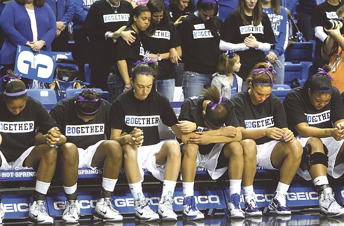 Fans and members of the Middle Tennessee women's basketball team take part in a moment of silence for teammate Tina Stewart, who was stabbed to death last week, before Sunday's game in Hot Springs, Ark. 