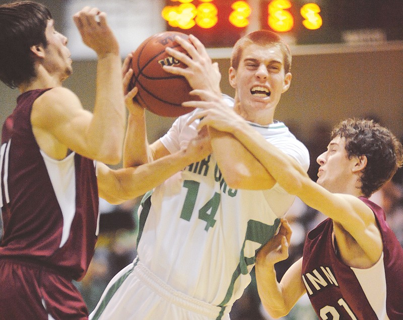 Brandon Moore (14) of Blair Oaks tries to drive past two Linn defenders during a game in January in Wardsville.