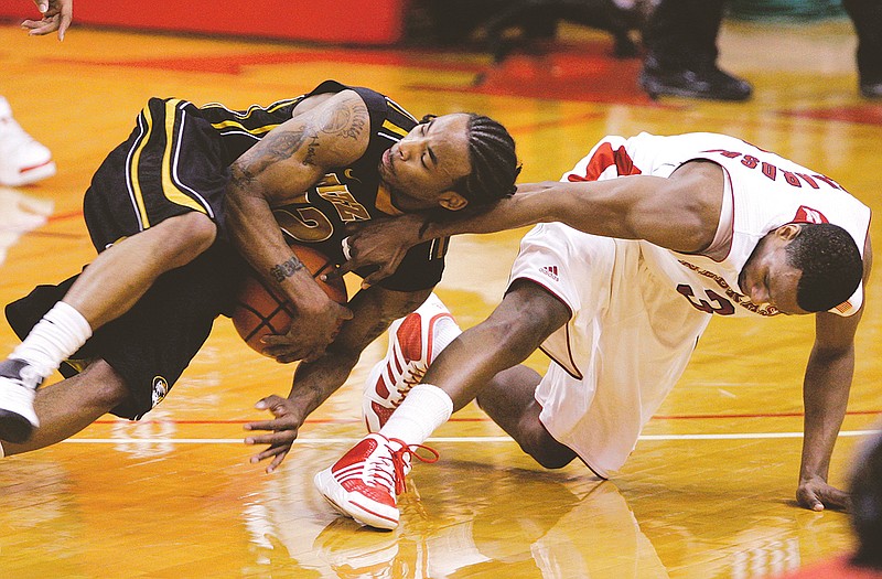 Marcus Denmon (left) of Missouri and Nebraska's Brandon Richardson tumble while going for a loose ball in the second half of a game earlier this month in Omaha, Neb.