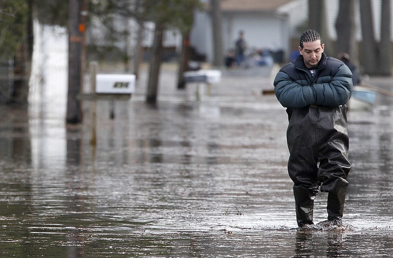 Eric Labrador, 25, wades through flood waters Tuesday in Wayne, N.J. Water had just begun subsiding from flooded parts of New Jersey when more rain was forecast for the region.