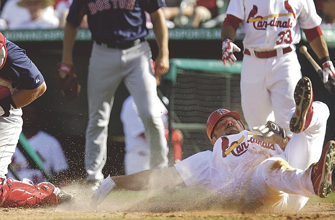 Nick Stavinoha of the Cardinals reaches for home plate while trying to score during the eighth inning of Tuesday's spring training game against the Red Sox in Jupiter, Fla. Stavinoha was called out on the play. 