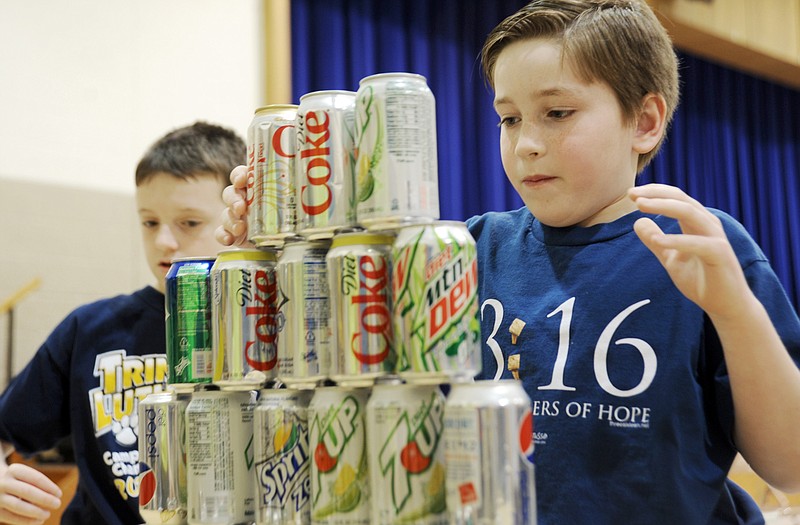 Connor Shanley, left, and his friend Matthew Bleidistel participated in Minute to Win It games at Trinity Lutheran School on Friday.