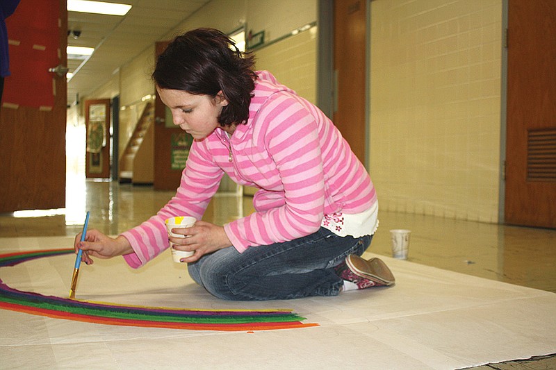 Mandi Steele/FULTON SUN photo: Sixth-grader Madonna Moore paints a rainbow for a piece she will use as scenery in her Destination Imagination skit.